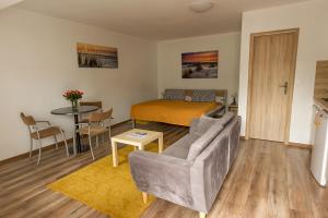 a living room with a couch and a bed at Apartmany Tereza & free parking in Bratislava