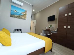 a hotel room with a bed and a bathroom at Domos La Corte Ghibellina in Iglesias