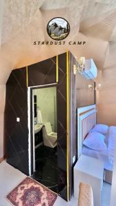 a small room with a couch and a mirror at RUM STARDUST lUXURY CAMP in Wadi Rum