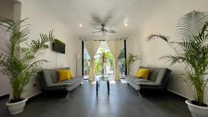 a living room with two couches and a table at Marisol Beach in Playa del Carmen