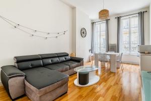 a living room with a couch and a table at SC Collection - Charme et Grandeur de la Lorette in Marseille +6 photos