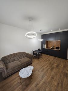 a living room with a couch and a table at Modern apartment in Klaipėda