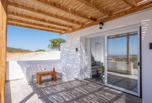 a room with a balcony with a table and chairs at Alisahni Studio Sea View in Paleochori