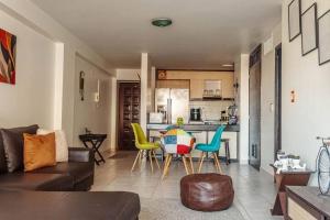 a living room with a couch and a table and chairs at Cozy Apartment in Maracaibo in Maracaibo