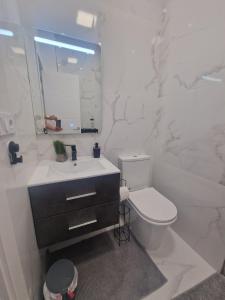 a white bathroom with a toilet and a sink at Casa estilo Riad Fez en Lo Pagan in San Pedro del Pinatar
