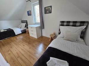 a bedroom with two beds and a window at North Port in Kopalino