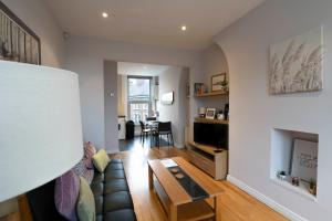 a living room with a couch and a table at Central, Stylish, & Modern Flat in Belfast