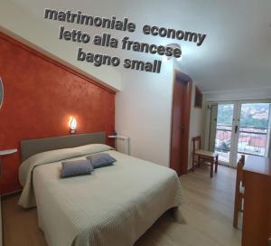 a bedroom with a bed with two pillows on it at Hotel Ristorante Supersonik in Acri
