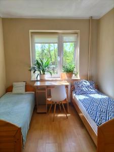 Posteľ alebo postele v izbe v ubytovaní Apartamenty i Pokoje Piaskowy Mak