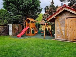a playground with a slide and a play house at holiday home, Kolczewo in Kołczewo