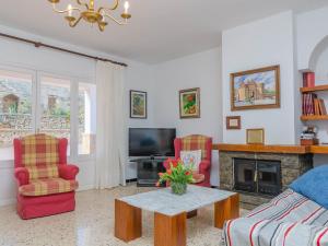 a living room with two chairs and a fireplace at Can Nicolau - Villa With Private Pool In Colònia De Sant Pere Free Wifi in Colonia de Sant Pere