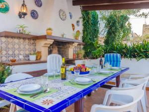 a blue table with white chairs and a table with food at Can Nicolau - Villa With Private Pool In Colònia De Sant Pere Free Wifi in Colonia de Sant Pere