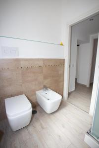 a bathroom with a white toilet and a sink at La finestra sul pincio in Civitavecchia