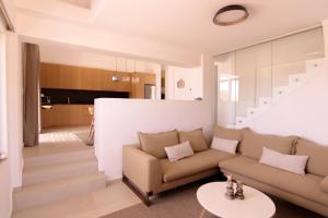 a living room with a couch and a table at Summer Villa Barbara ,private pool in Mikonos