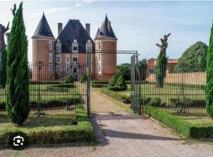 an entrance to a castle with a gate in front of it at Maison à Saint elix le château in Saint-Élix-le-Château