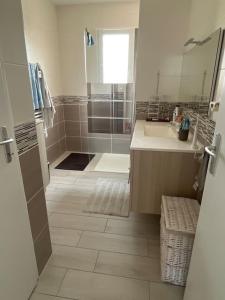 a white bathroom with a shower and a sink at Maison à Saint elix le château in Saint-Élix-le-Château
