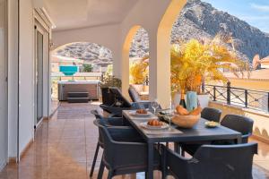 a patio with a table and chairs on a balcony at Ocean View Luxury Villa in Los Cristianos