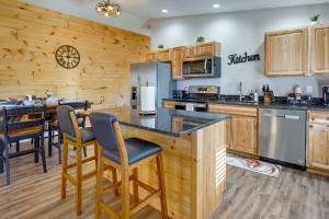een grote keuken met houten kasten en een aanrecht bij Serene Logan Retreat with Private Hot Tub and Fire Pit in Logan