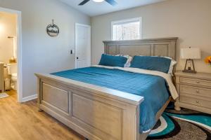 een slaapkamer met een groot bed met blauwe lakens bij Serene Logan Retreat with Private Hot Tub and Fire Pit in Logan