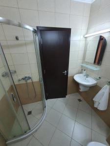 a bathroom with a shower and a toilet and a sink at Таня 10 in Pomorie +31 photos
