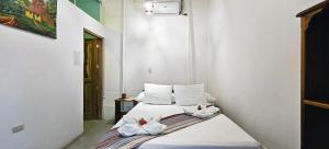 a bedroom with two beds with towels on them at Casa Oro Eco Hostel in San Juan del Sur +145 photos