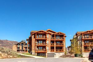 an apartment building with balconies on the side of a street at Village at the Shores 201 by Moose Management in Cranmer