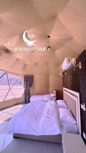 a bedroom with a bed in a room at RUM JOHARH lUXURY CAMP in Wadi Rum
