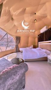 a bedroom with a large bed in a tent at RUM JOHARH lUXURY CAMP in Wadi Rum