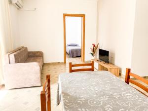 都拉斯的住宿－LunaSol seaside Apartments，客厅配有床、椅子和电视