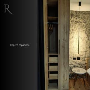a room with a wooden closet with a ladder at Roca Lodge in Quito +10 photos