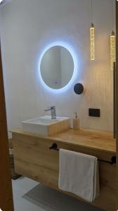 a bathroom with a sink and a mirror at Roca Lodge in Quito