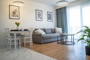 a living room with a couch and a table at Duży apartament in Gdańsk +8 photos