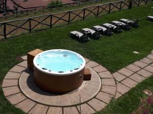 a large hot tub with a row of chairs in a yard at Portico Del Paradiso in Scala