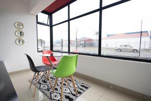 a dining room with a table and chairs in front of a window at Safi Luxury Apartment - 3 in East London