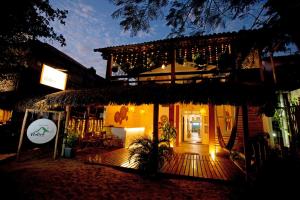 a building with a deck at night with lights at Pousada Nativa Jeri in Jericoacoara