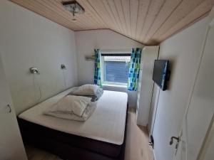a small room with a bed and a window at Holiday house by a fantastic beach and free WiFi in Slagelse +34 photos