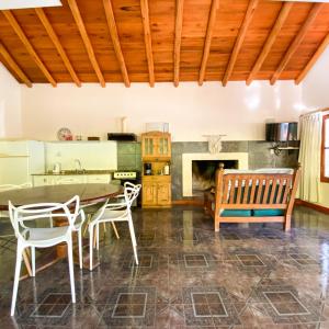 a kitchen with a table and chairs and a fireplace at El Solar Casas de Campo 3 in Valle Grande