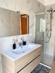a bathroom with a white sink and a shower at Mediterraneo in Chieti +23 photos