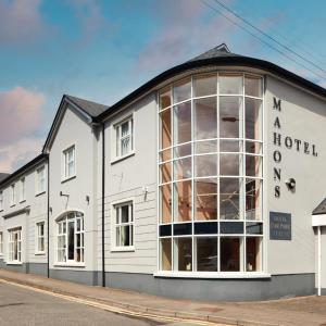 a large white building with a large window at Mahon's Hotel in Irvinestown