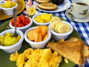 a green plate of breakfast food with toast and fruit at Casa Colibri Palomino in Palomino