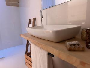 a white sink on a counter in a bathroom at Recinto antico Sweet Rooms in Matera