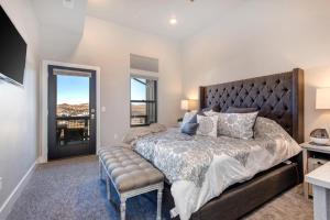 a bedroom with a large bed and a window at Mayflower Lakeside 301-21 by Moose Management in Heber City