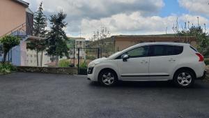 a small white car parked in a parking lot at Studio le Puy-en-Velay in Le Puy en Velay