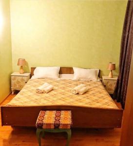 a bedroom with a bed with two towels on it at Shmagdas House Sighnaghi შმაგდას სახლი სიღნაღში in Sighnaghi