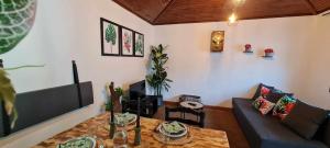 a living room with a table and a couch at Carlana House in Paredes de Coura