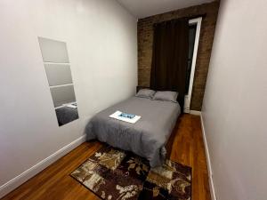 a bedroom with a bed with a table in it at Cozy Townhouse in Harlem in New York