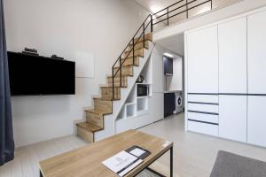a living room with a staircase and a table at Park View Terrace in Paju