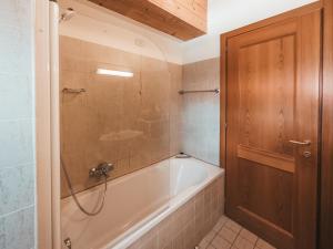 a bathroom with a bath tub and a shower at ALPENNEST - AlpenLuxus Collection in Seefeld in Tirol