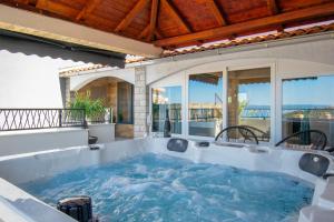 a hot tub on the patio of a house at Luxury Dream House Nea with jacuzzi in Makarska