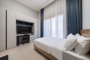 a hotel room with a bed and a television at Park View Terrace in Paju